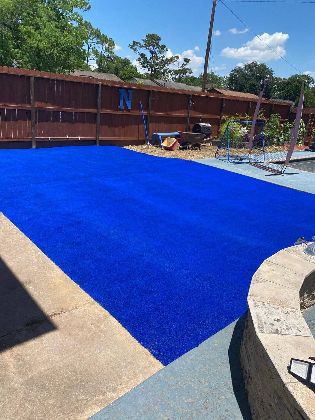 Custom blue synthetic turf play and sports area with a soccer goal